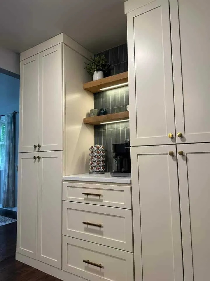 Custom painted kitchen cabinetry with glass upper doors and deep drawer banks